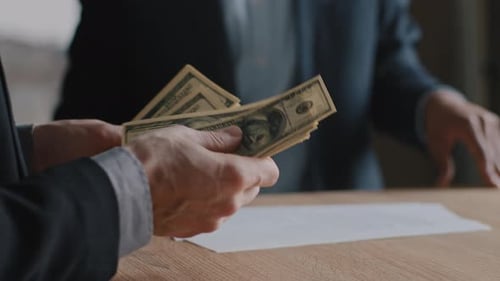 Businessmen Count Money and Shake Hands on Deal