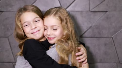 Two Adorable Girls Embrace