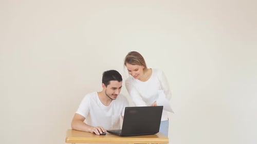 Young Adults Working Together at Laptop Computer