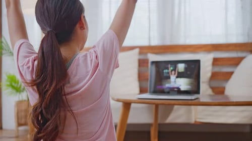 Woman Doing Yoga Class At Home