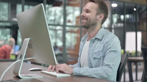Young Adult Male Working at Office Computer