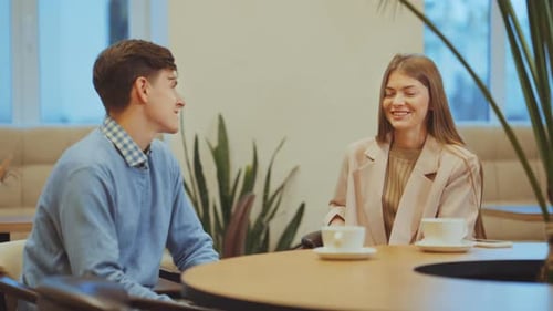 Young People Having Romantic Date in Cafe