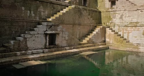 Ancient Stepwell with Stone Staircases and Pool