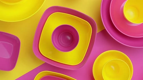 Rotating Bright Yellow and Pink Plastic Plates and Bowls