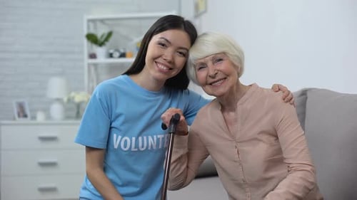 Volunteer and Senior Woman Smiling Together