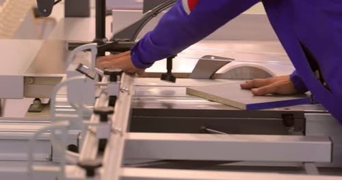 Machine Cutting Wood in Industrial Setting