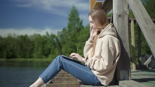 Woman Typing on Laptop Working Freelance on Pier Spbd