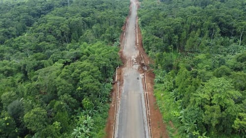 Land clearing for the highway from aerial drone footage of forward motion