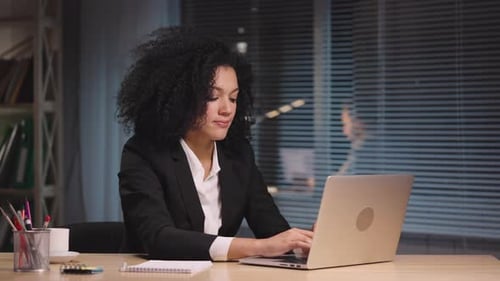 Woman Working on Laptop Then Relaxing at Desk