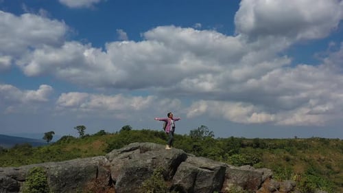 Drone view Young hiking man walking to peak of mountain