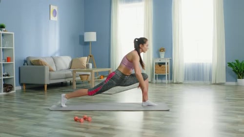 Woman Stretches on Yoga Mat Indoors