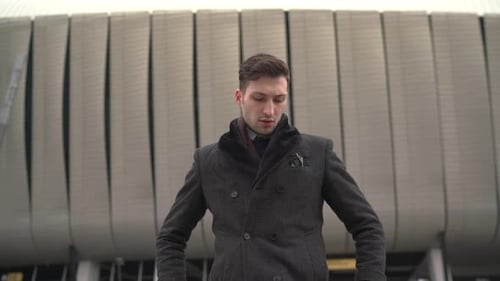 Stylish Man Fastens Coat in City