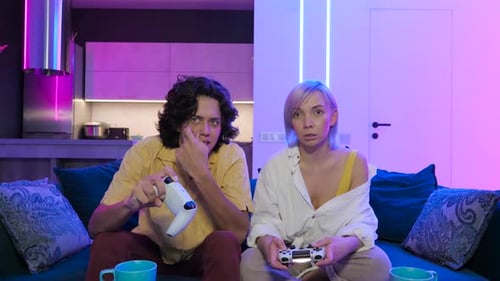 Young Couple Playing Video Games at Home