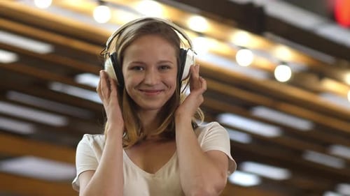 Woman Smiling, Listening to Music on Headphones