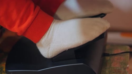 Feet On Pedals Of Car Simulator