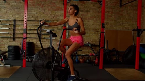 Lovely Active Sporty Fitness African American Female Riding Exercise Bike at Gym