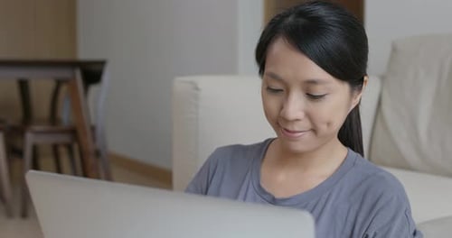 Woman Working on Laptop in Bright Home Interior