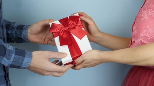 Woman Presents Gift to Man, Blue Background