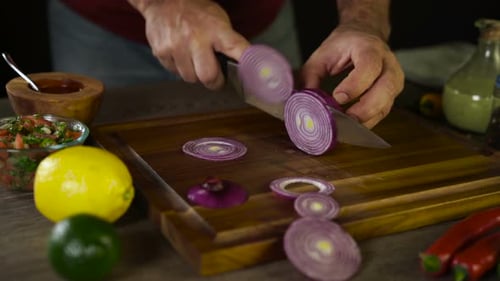 Chef Slicing Onion Rings For Fresh Salsa
