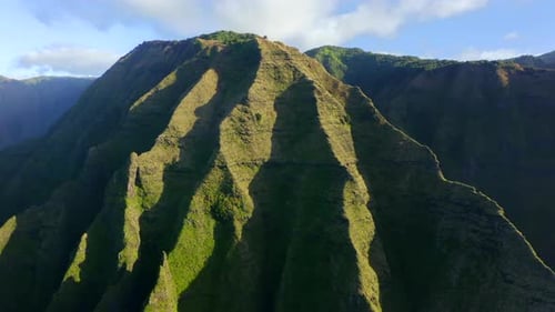 Scenic,ribbed Hawaiian Mountain Lit with the Sun Under the Blue Sky. Aerial View