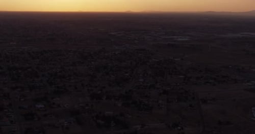 Helicopter aerial shot over mountainous landscape and forest, day