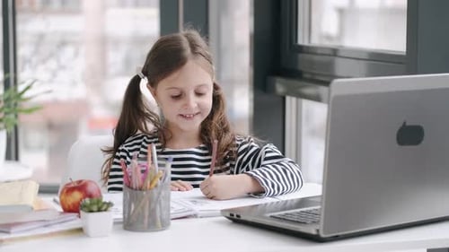 Girl Studies and Waves at Laptop at Home