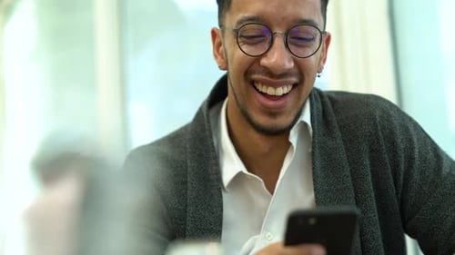 Businessman using smartphone in a restaurant