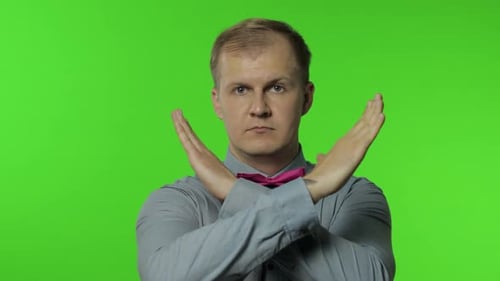 Man Crossed His Arms in X Sign and Saying No, Warning of Finish, Prohibited Access. Telling To Stop