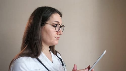 Medical Professional Using Tablet Indoors