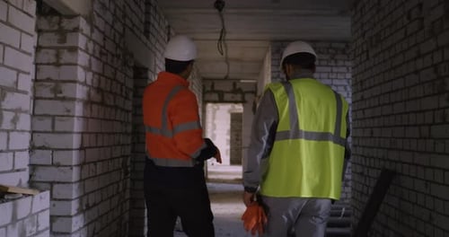Construction Engineers Inspecting Building Interior