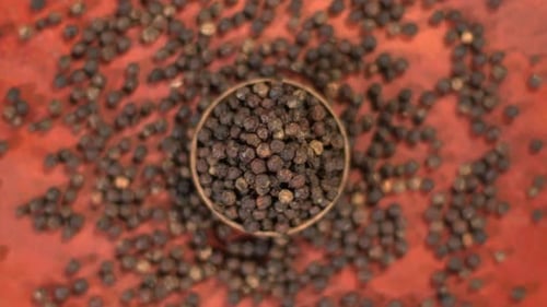 Aromatic Black Peppercorns in Rustic Bowl