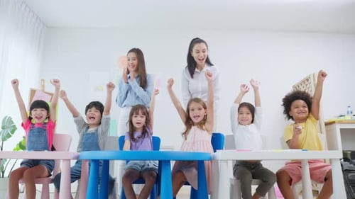 Enthusiastic Young Students Celebrating Success in Classroom