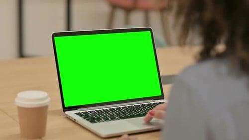 African Woman Using Laptop with Green Chroma Key Screen