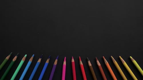 Wooden School Pencils of Different Colors Are Located on the Black Surface. Stop Motion Animation