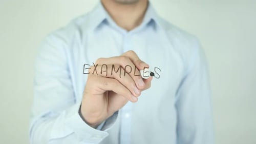 Man Writing 'Examples' on Clear Surface