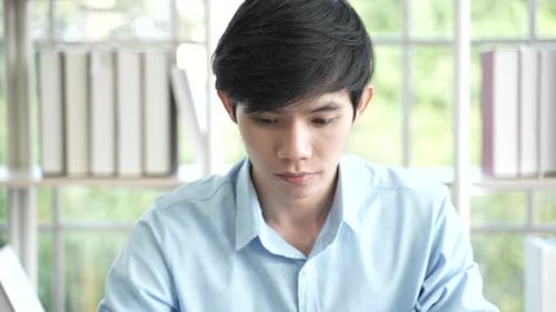 Focused Young Adult Concentrating at Desk Indoors