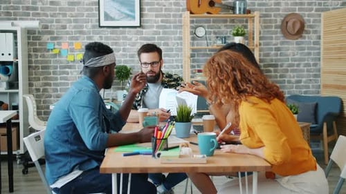 Diverse Team Brainstorming Ideas at Office Table