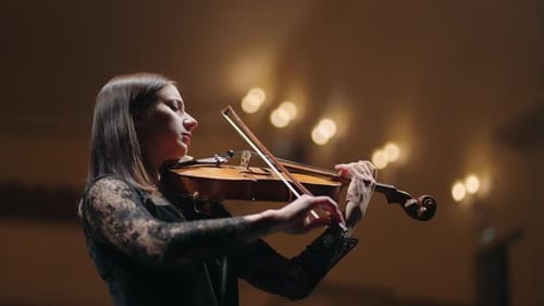 Woman is Playing Old Fiddle Female Musician in Symphonic Orchestra Violinist on Scene of Music Hall