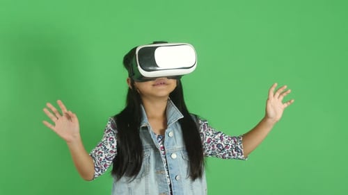Child Wearing VR Headset Gesturing on Green Screen