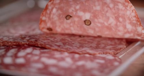 Hand Places Sliced Salami, Macro Shot