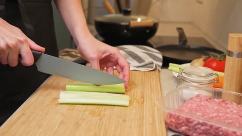 Woman Cuts Celery Slices
