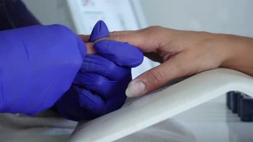 Manicurist Filing Nails in a Beauty Salon