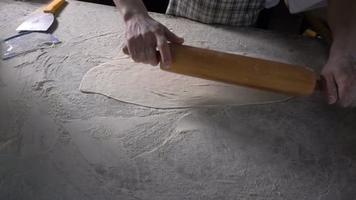 Rolling Out Dough With Flour To Make Turkish Pita