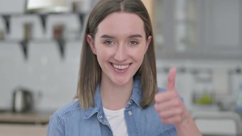 Young Woman Smiling and Giving a Thumbs Up
