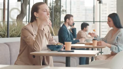Young Woman Having Pan Asian Food for Lunch at Food Court