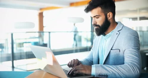 Young Handsome Architect Working on Laptop in Office