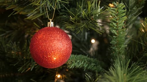 Decorative bauble on the branch close-up 4K 2160p 30fps UltraHD footage - Red glittering ornament