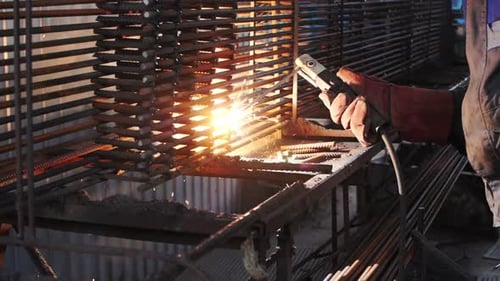 Industrial Welder Working on Metal Bars