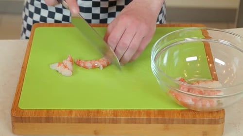 Person Cutting Shrimp on Cutting Board Close Up
