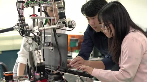 Engineer collaborating development robot in modern laboratory